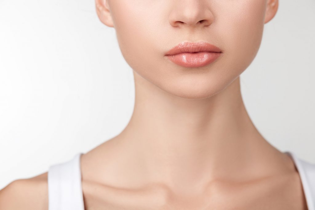 Close up of female neck and half of face. The beautiful woman has perfect skin. Isolated